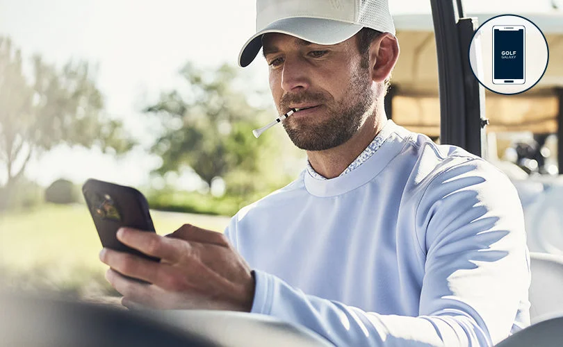 A golfer browsing the app on his phone for the latest gear.
