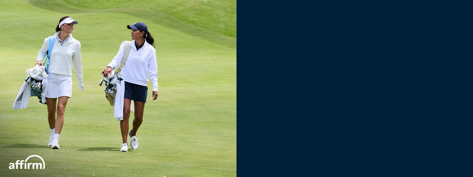 Two women walking on a fairway.