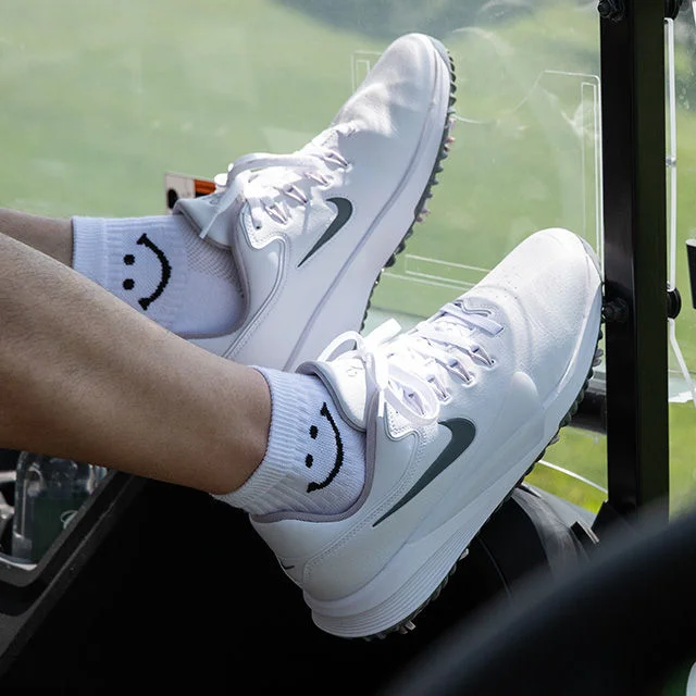 White athletic sneakers with smiley socks