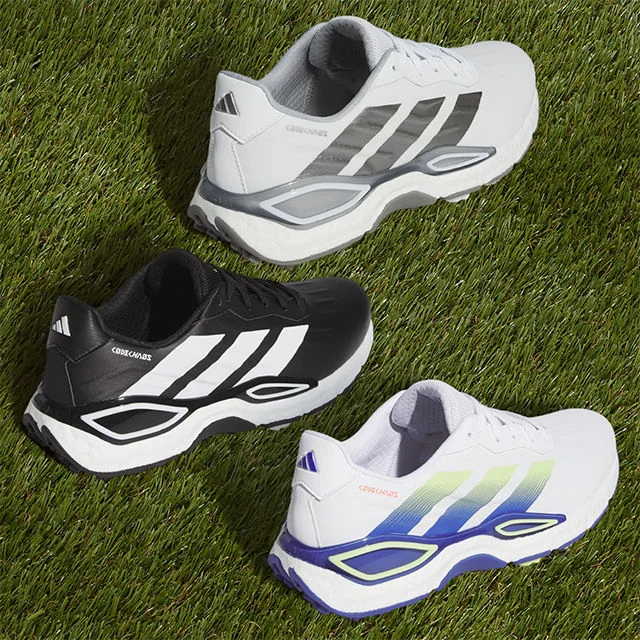 Adidas shoes on grass.
