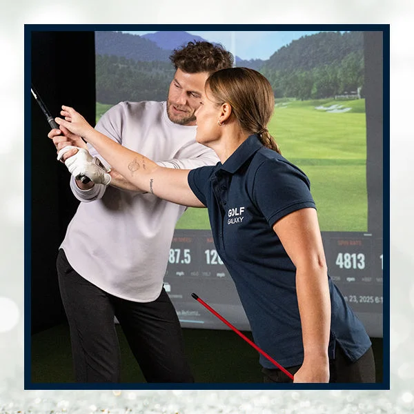 A man receiving golf lessons.