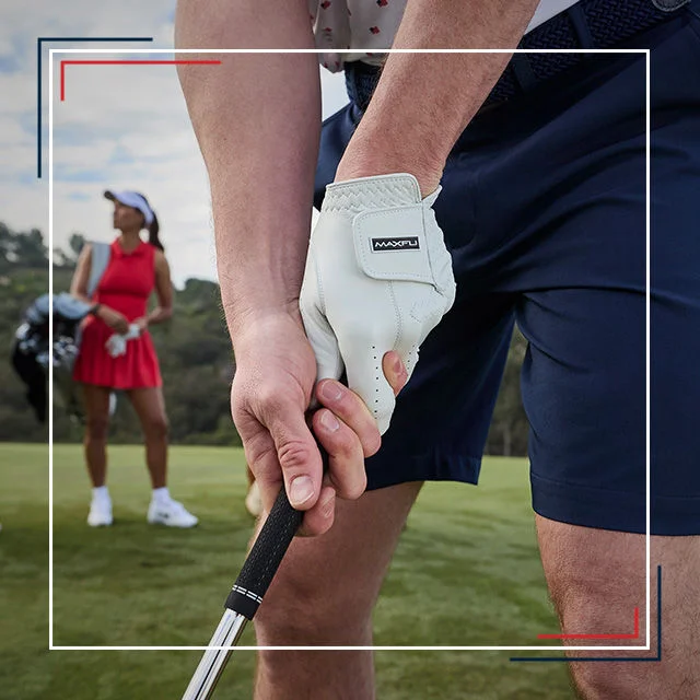 Man holding golf club. Female golfer in background.