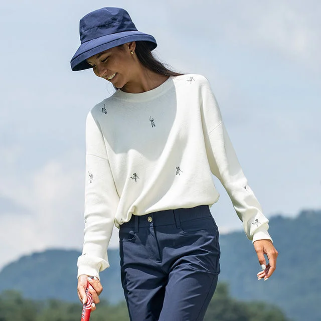 Woman in bucket hat walking outdoors