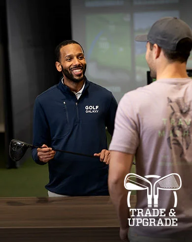 Trade and upgrade. Golfer and Golf Galaxy teammate discussing club trade and upgrade options.