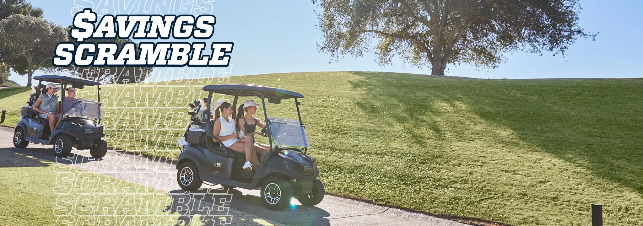 A foursome driving golf carts to a tee box. 