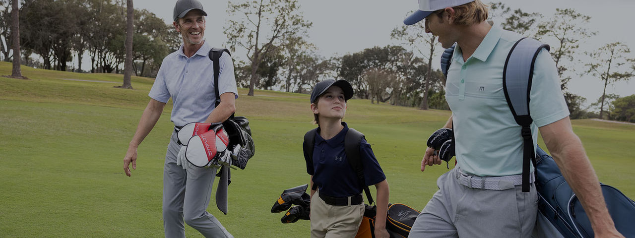 Golfers walking on course.