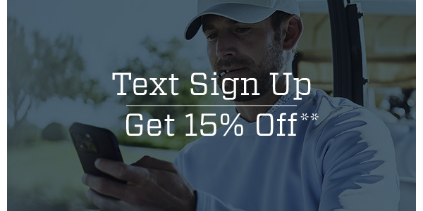 A golfer looking at a text message on his phone.
